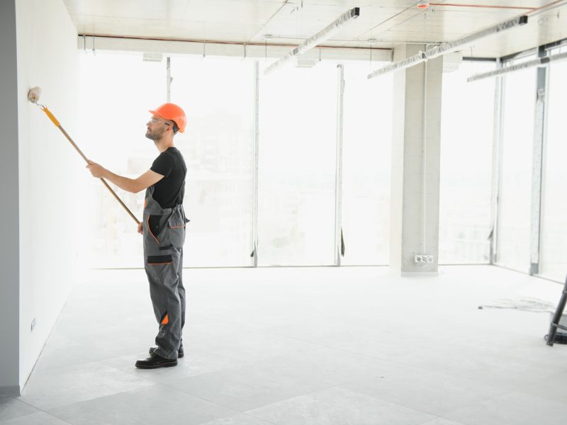 Male workers doing interior renovation in apartment.