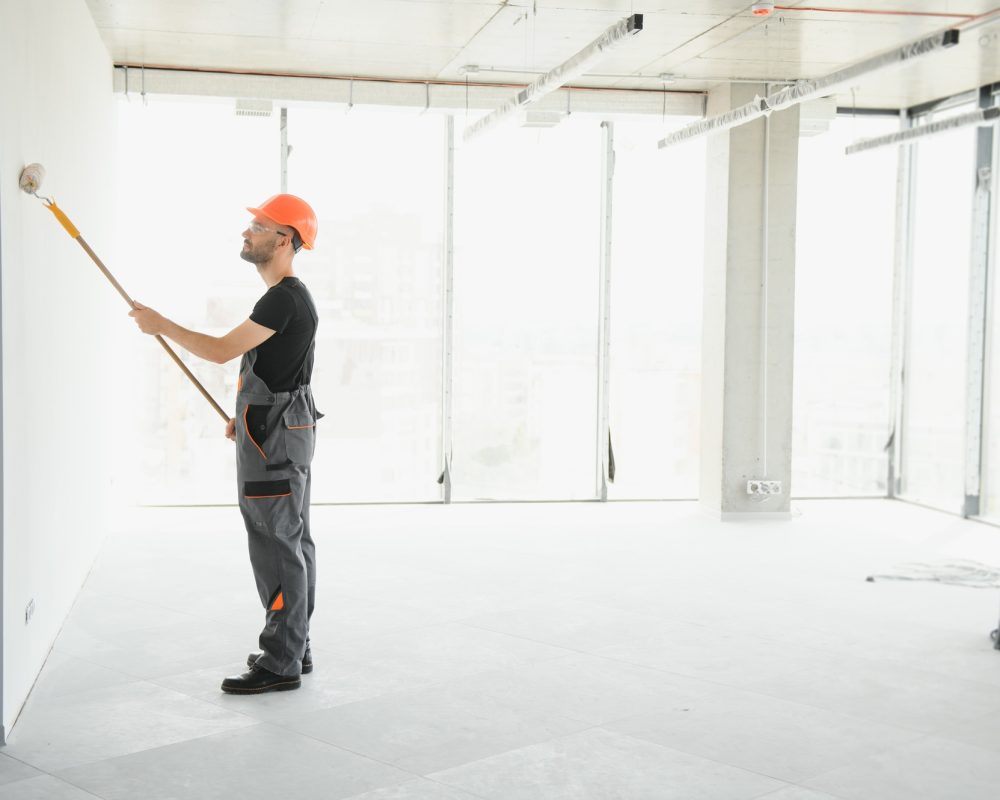 Male workers doing interior renovation in apartment.